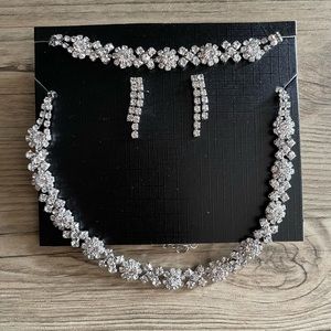 Matching jewelry set (bracelet, earrings, and necklace).